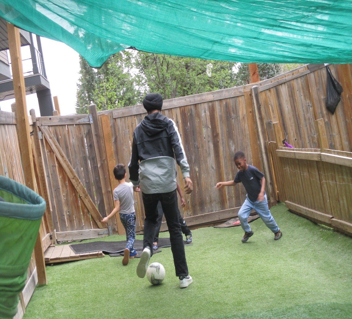 Children playing soccer outdoors